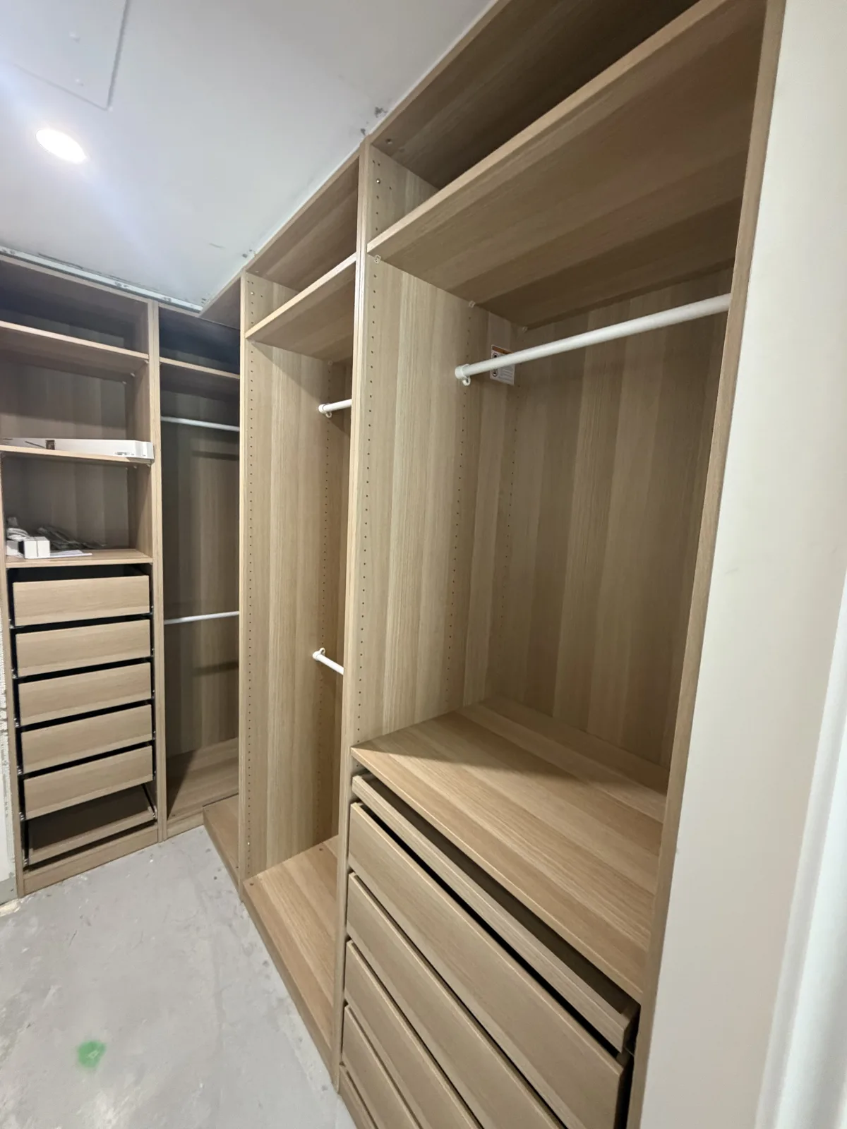 Open wardrobe with hanging rails, shelves and drawers